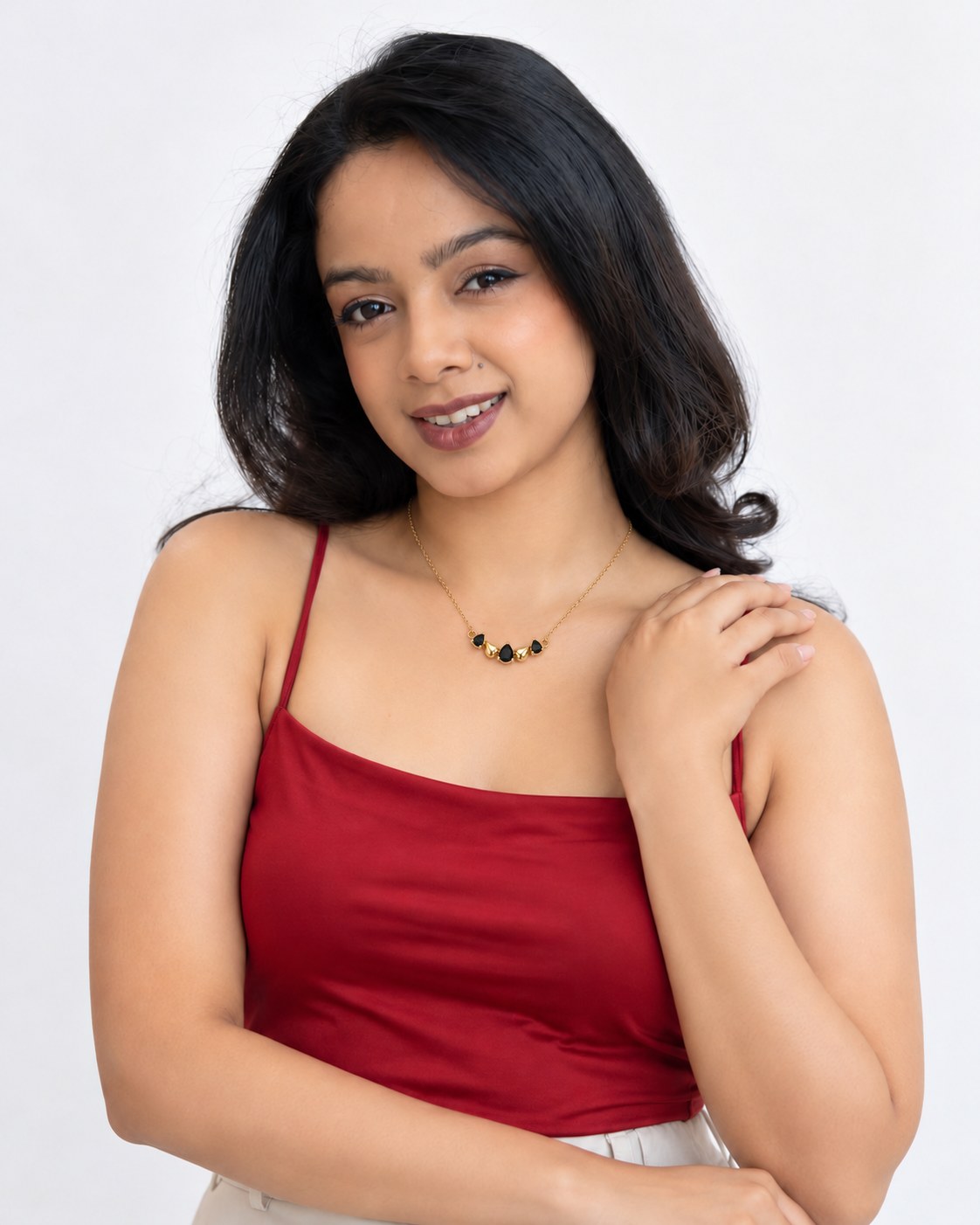 Paired model wearing the Raven Drops Chain in black with a red camisole
