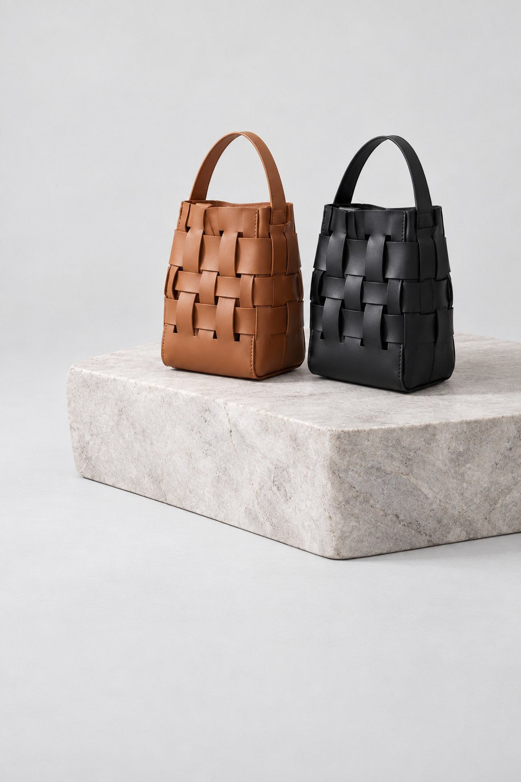 Paired woven leather bags in tan and black