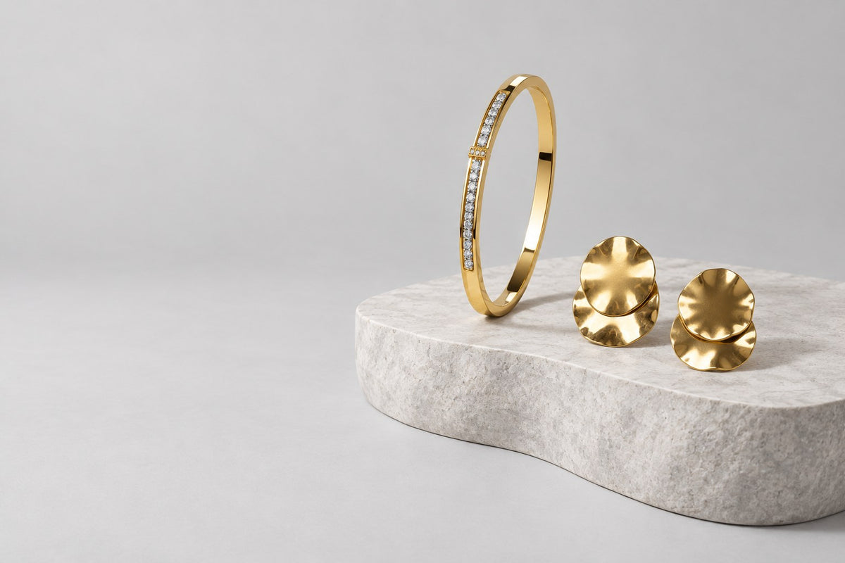 Paired gold crystal bangle and gold earrings