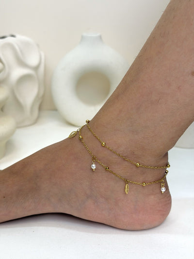 Paired Aurevia Anklet in gold-tone, side view on the ankle with two beaded chains and pearl-like drops