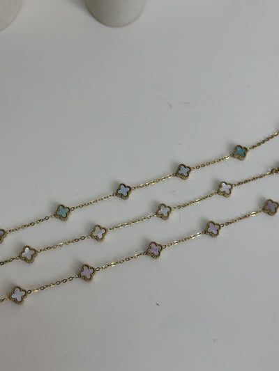 Paired Clover Petite Bracelet in gold-tone, three bracelets laid flat showing pastel clover motifs in different tones