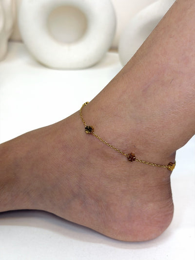 Paired Elara Anklet in gold-tone, side view on the ankle with double chains and flower charms