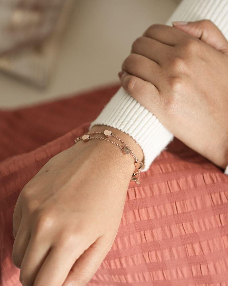 Paired jewellery worn: bracelets heart charm