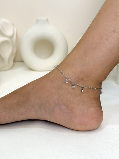 Paired Lunelle Anklet in silver-tone, side view on the ankle with small clear drop stones along the chain