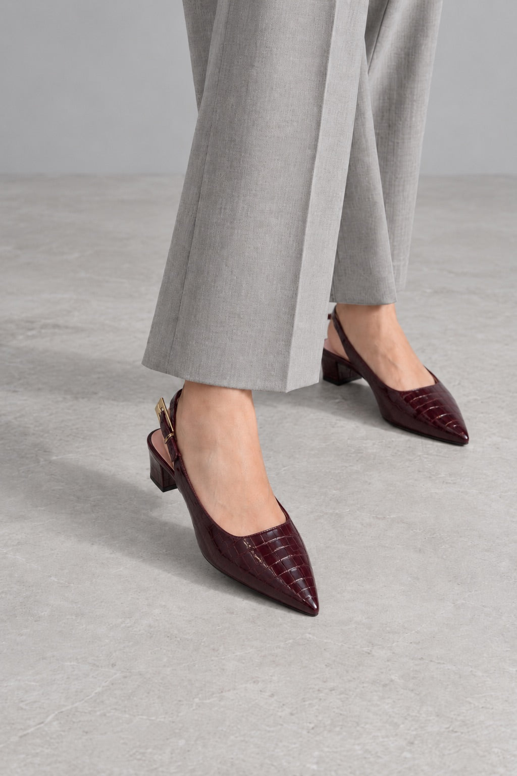 Burgundy croc slingback heels with grey tailored trousers