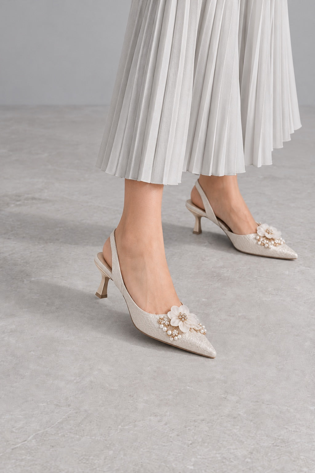 Ivory floral slingback heels with a pleated skirt