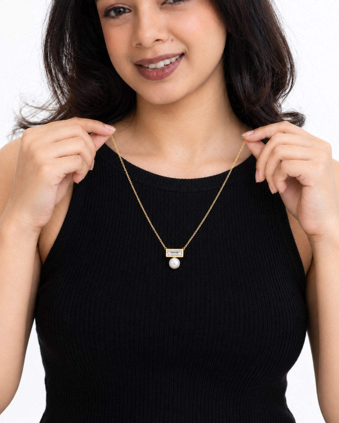 Paired Radiant Love Chain in gold-tone, held up by the model to show the fine adjustable 19 to 21 inch chain