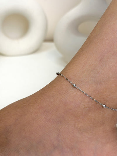 Paired Solène Anklet in silver-tone, close-up on the ankle with ball beads along a fine chain